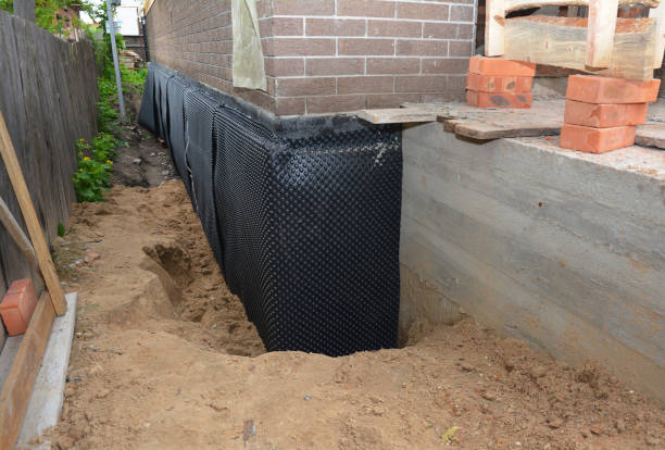 Happy homeowners after waterproofing job in Bedford
